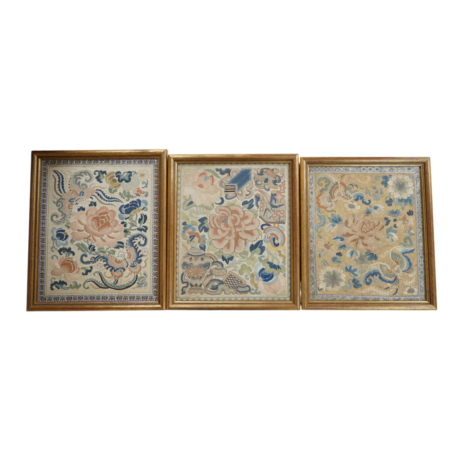 Three mid 19th century cream silk polychrome embroidered panels, possibly from a skirt, with woven silk braiding, largest 26cm wide, 30.5cm high. Condition - good